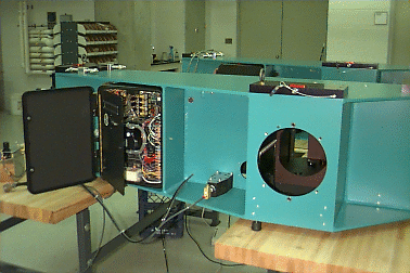 A blue table with a door opened showing electronics